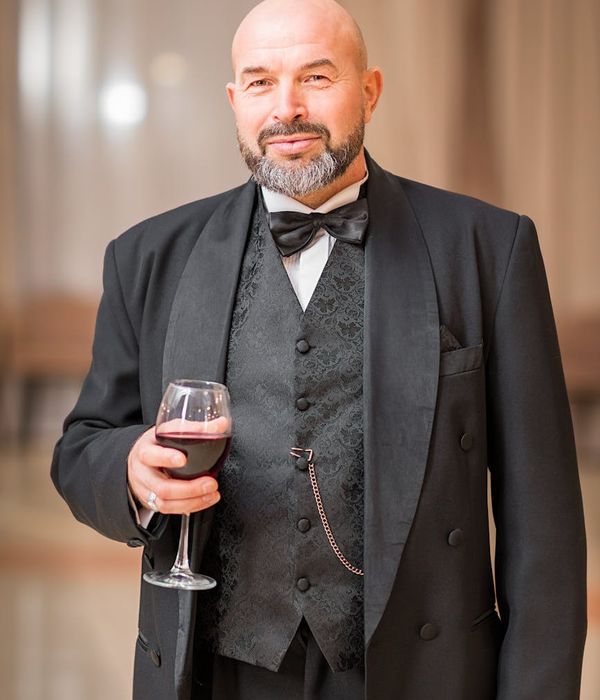 A man with a focused expression sitting after a workout, looking energized.